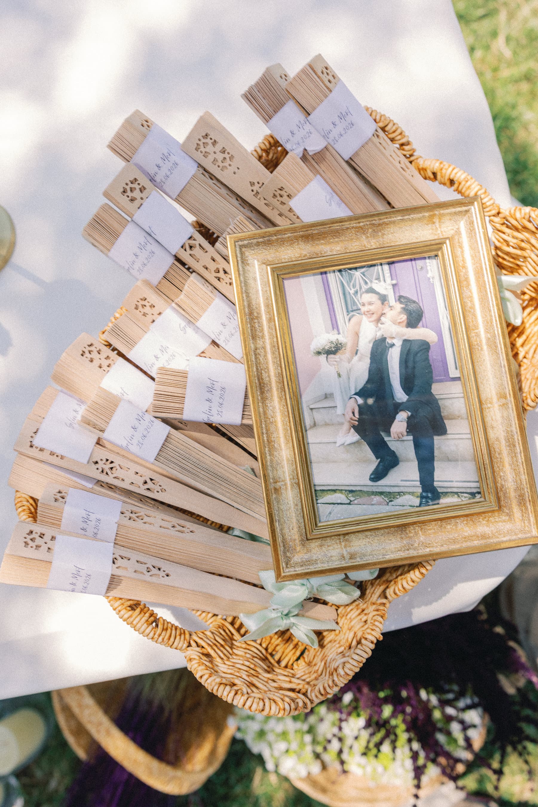 Düğün girişinde sepet içinde yelpazeler ve çerçeveli çift fotoğrafı